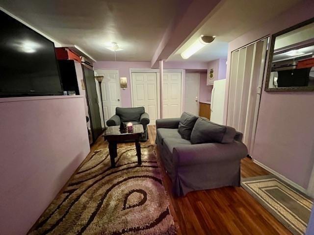 living room with baseboards and wood finished floors
