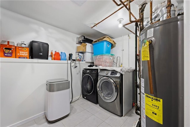 washroom featuring light tile patterned floors, separate washer and dryer, and water heater