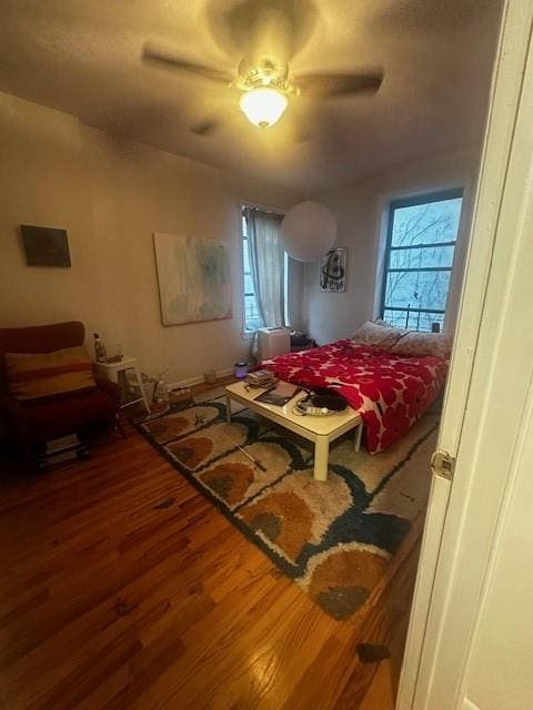 bedroom featuring hardwood / wood-style flooring and ceiling fan