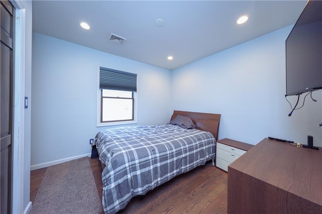 bedroom with dark hardwood / wood-style floors