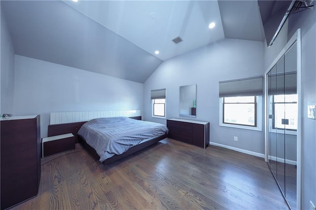 bedroom with dark hardwood / wood-style floors and lofted ceiling