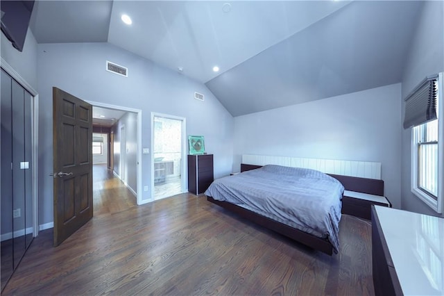 bedroom with dark wood-type flooring, a closet, and lofted ceiling