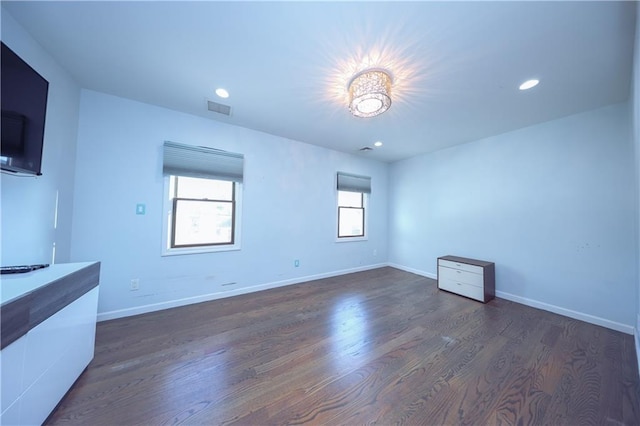 unfurnished living room featuring dark hardwood / wood-style floors