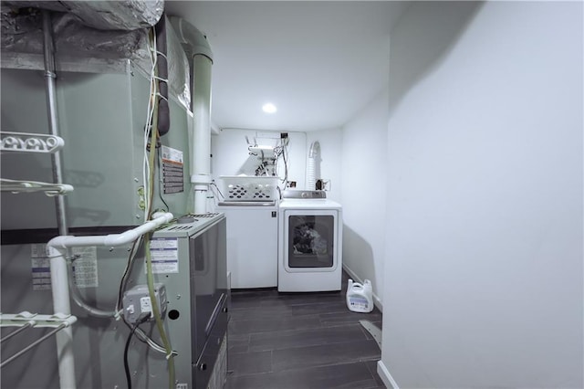 laundry room with separate washer and dryer and heating unit