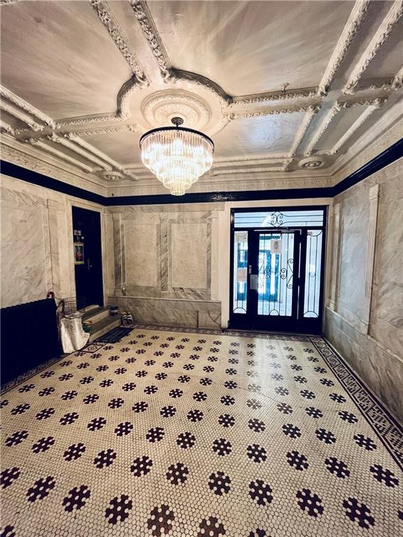 basement with a chandelier, crown molding, and carpet floors