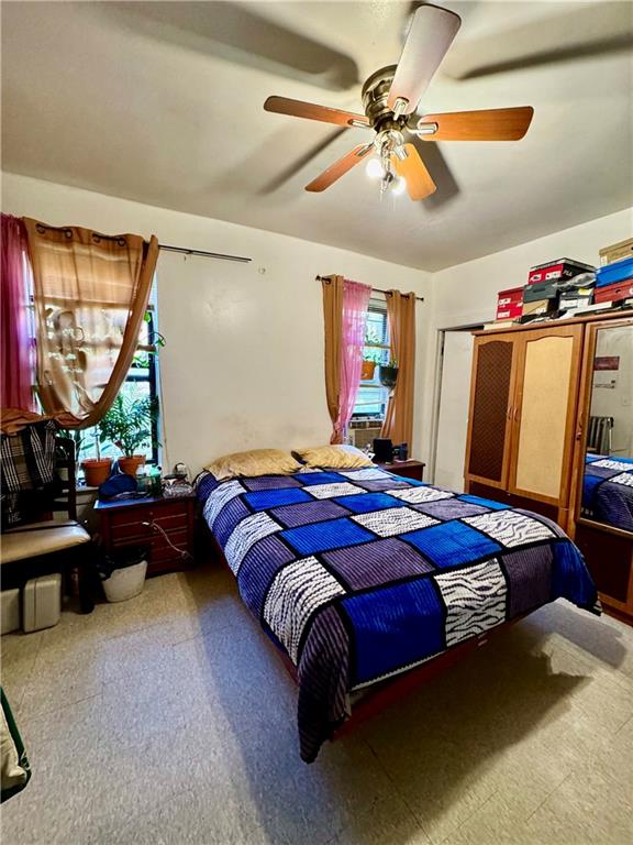 bedroom with ceiling fan and multiple windows