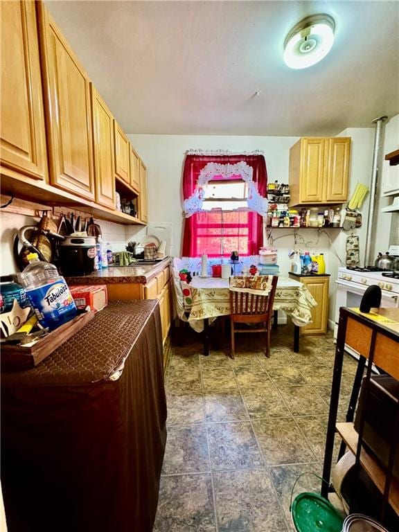 kitchen featuring white range with gas cooktop