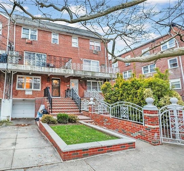 view of property featuring a garage and a balcony