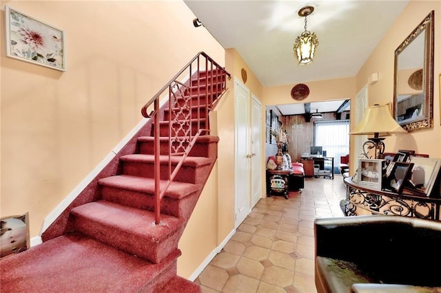 staircase featuring tile patterned floors