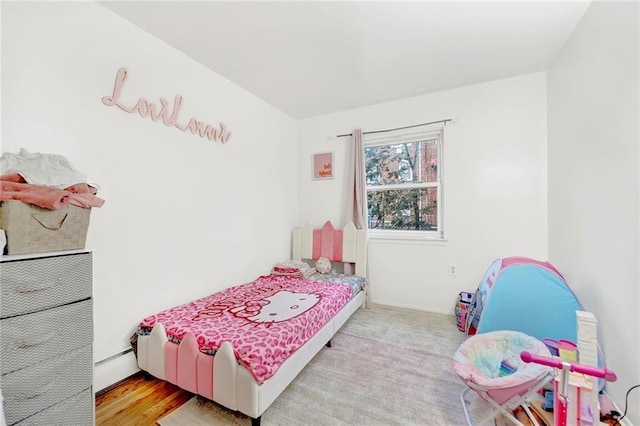 bedroom featuring light hardwood / wood-style floors and baseboard heating