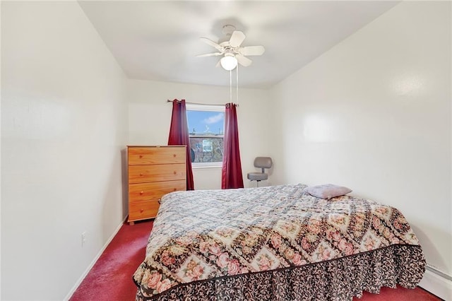 bedroom featuring ceiling fan, a baseboard heating unit, and dark carpet