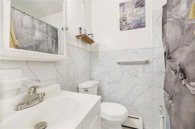 bathroom with vanity, toilet, tile walls, and baseboard heating