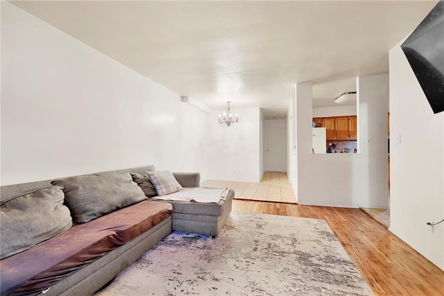 living room featuring light hardwood / wood-style floors and an inviting chandelier