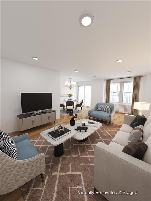 living room with an inviting chandelier, recessed lighting, and wood finished floors