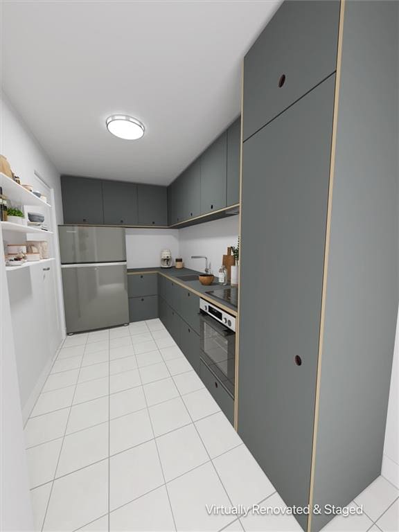 kitchen featuring light tile patterned flooring, gray cabinetry, stainless steel appliances, and a sink