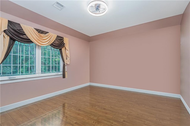 empty room featuring wood-type flooring