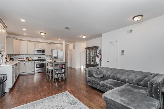 living room with dark hardwood / wood-style floors and sink