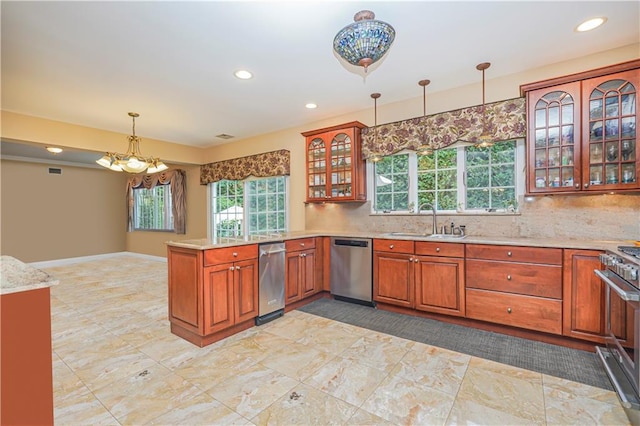 kitchen with a sink, a peninsula, a wealth of natural light, and stainless steel appliances
