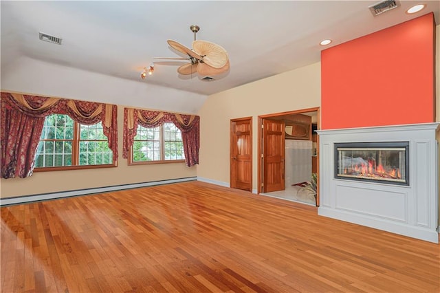 unfurnished living room with visible vents, a baseboard radiator, light wood-style flooring, and vaulted ceiling