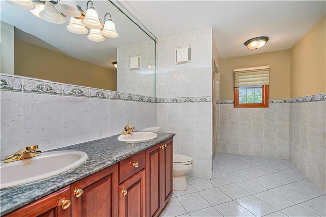 full bath with a sink, tile walls, an inviting chandelier, and tile patterned floors