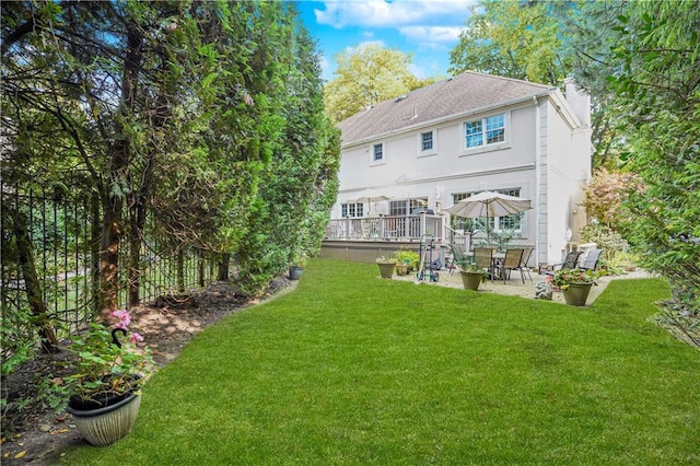 back of house with a yard, a patio, and stucco siding