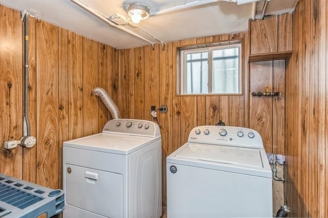 washroom featuring separate washer and dryer and wooden walls