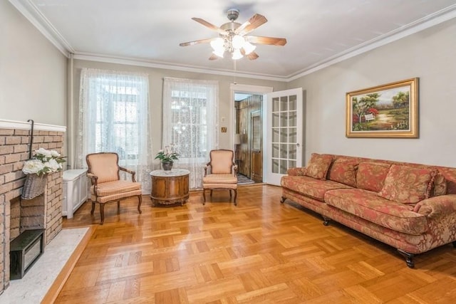 living room featuring ceiling fan, ornamental molding, a brick fireplace, and light parquet floors