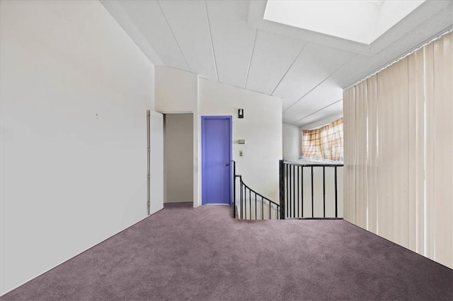 empty room with lofted ceiling and carpet flooring