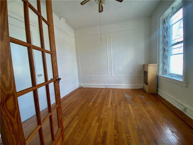 spare room featuring wood-type flooring and ceiling fan