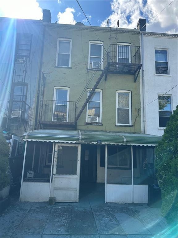 exterior space with a sunroom and a balcony