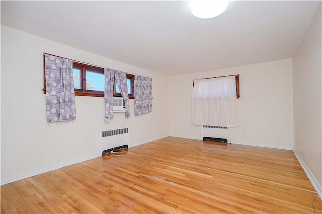 unfurnished room with wood-type flooring and radiator