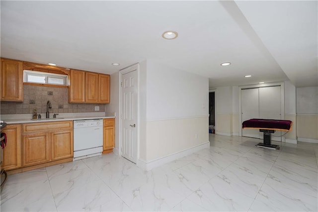 kitchen featuring sink, backsplash, and dishwasher