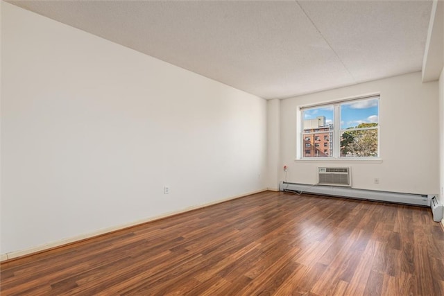 unfurnished room featuring dark wood-type flooring, baseboard heating, and a wall unit AC