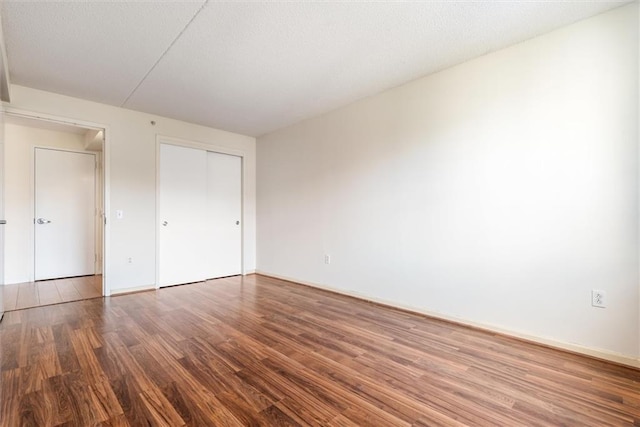 unfurnished bedroom with wood-type flooring and a closet