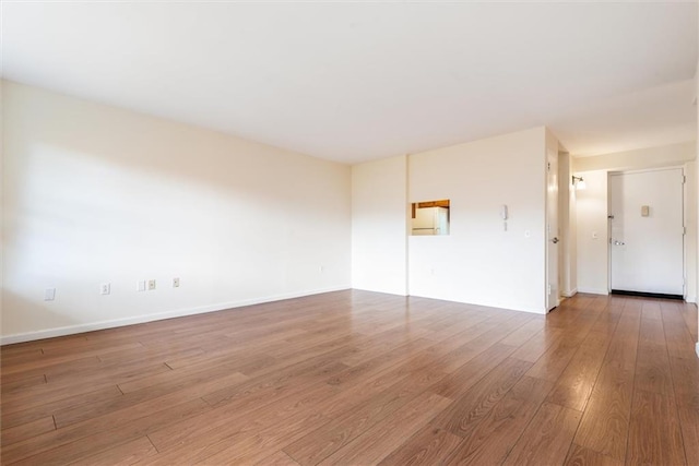 interior space with wood finished floors and baseboards