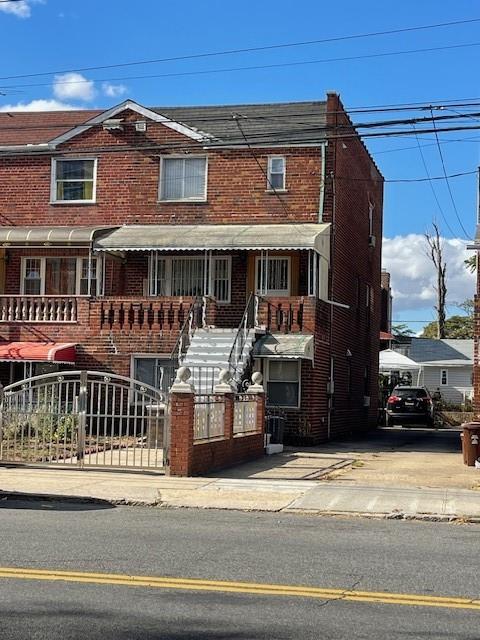 view of front of home with a fenced front yard and brick siding
