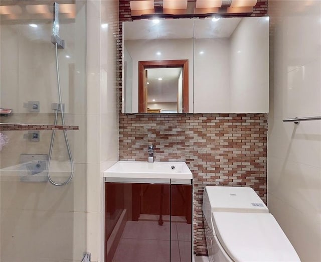 bathroom with walk in shower, vanity, tasteful backsplash, and tile walls