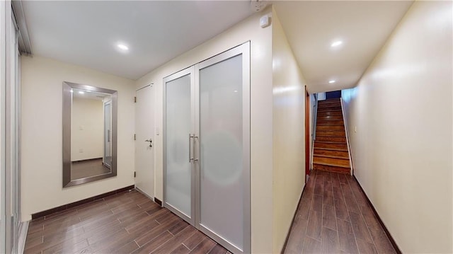 corridor featuring stairway, baseboards, dark wood-style floors, and recessed lighting
