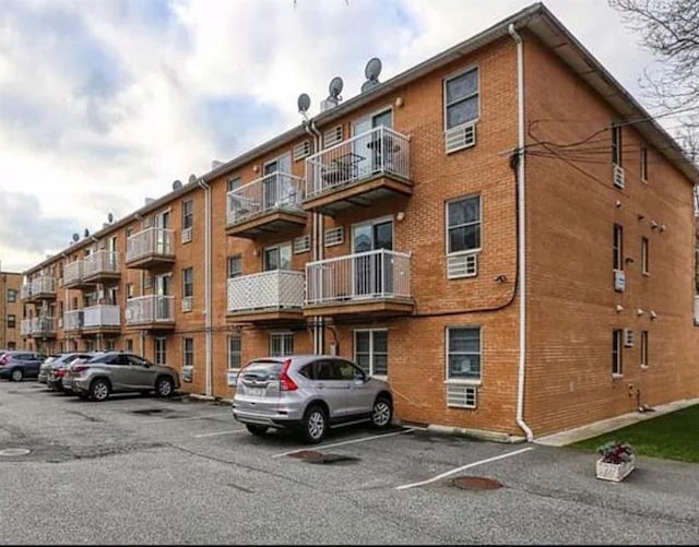 view of building exterior featuring uncovered parking