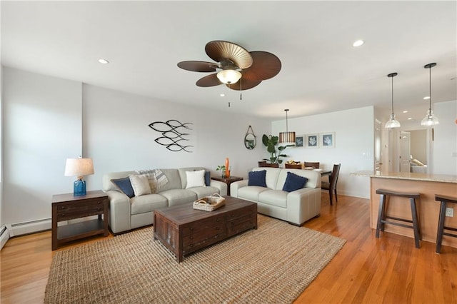 living room featuring light hardwood / wood-style floors and ceiling fan