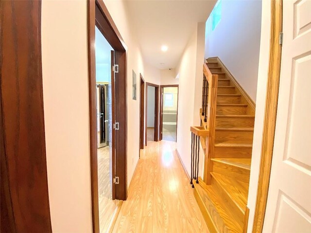 corridor with light hardwood / wood-style floors