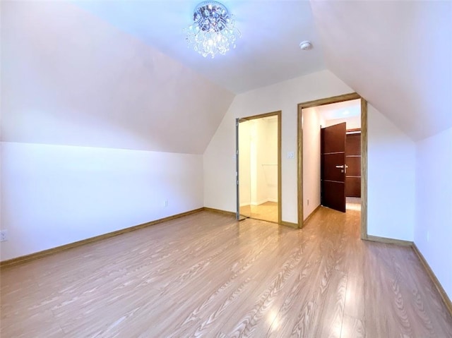 bonus room featuring vaulted ceiling and light hardwood / wood-style flooring