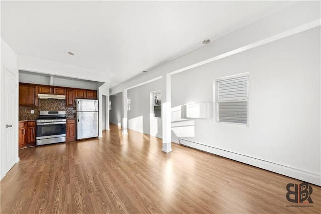 unfurnished living room with a baseboard radiator and hardwood / wood-style floors