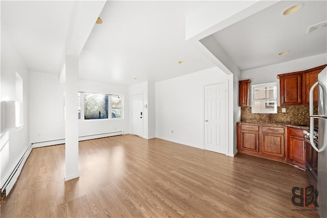 unfurnished living room with light hardwood / wood-style flooring and a baseboard radiator