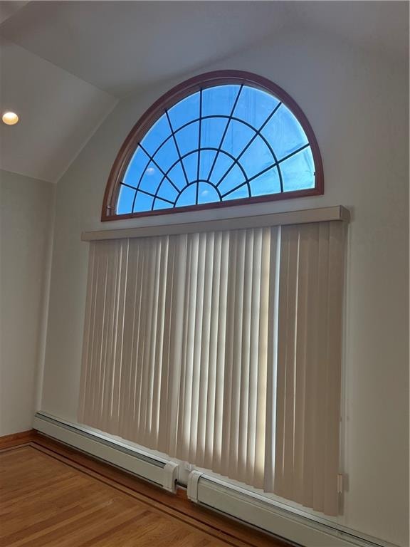 details featuring a baseboard radiator, wood finished floors, and recessed lighting