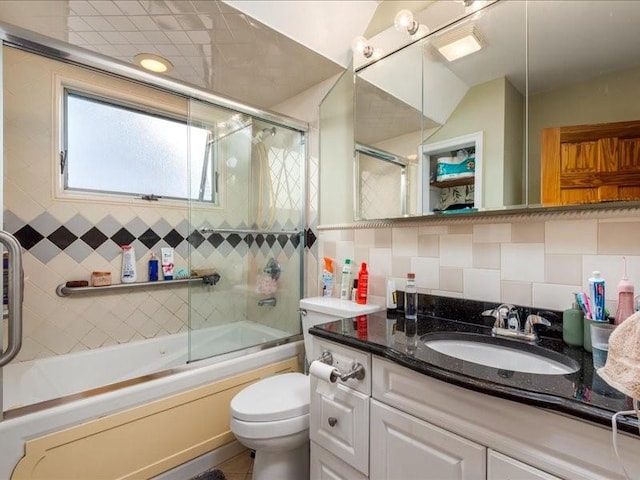 full bath with decorative backsplash, toilet, enclosed tub / shower combo, vanity, and tile walls