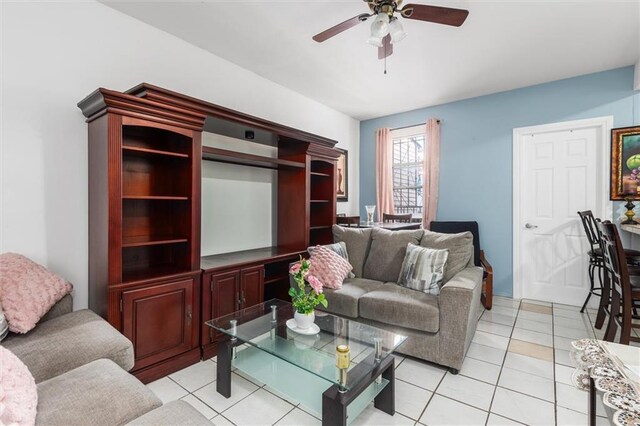 tiled living room featuring ceiling fan