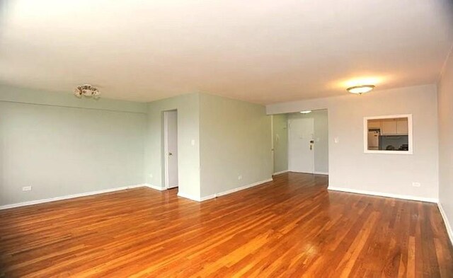 empty room with hardwood / wood-style floors