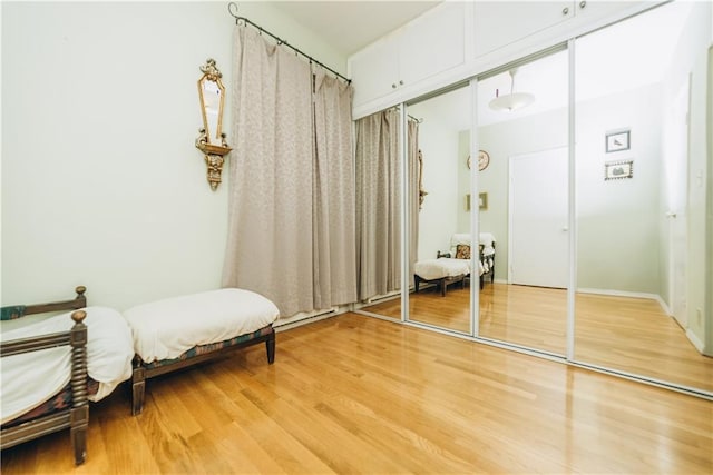 bedroom featuring light wood-style floors and a closet