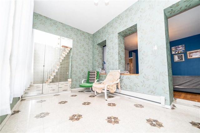 sitting room with wallpapered walls, tile patterned floors, and baseboards